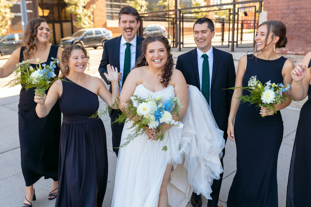 candid bride and groom and their wedding party