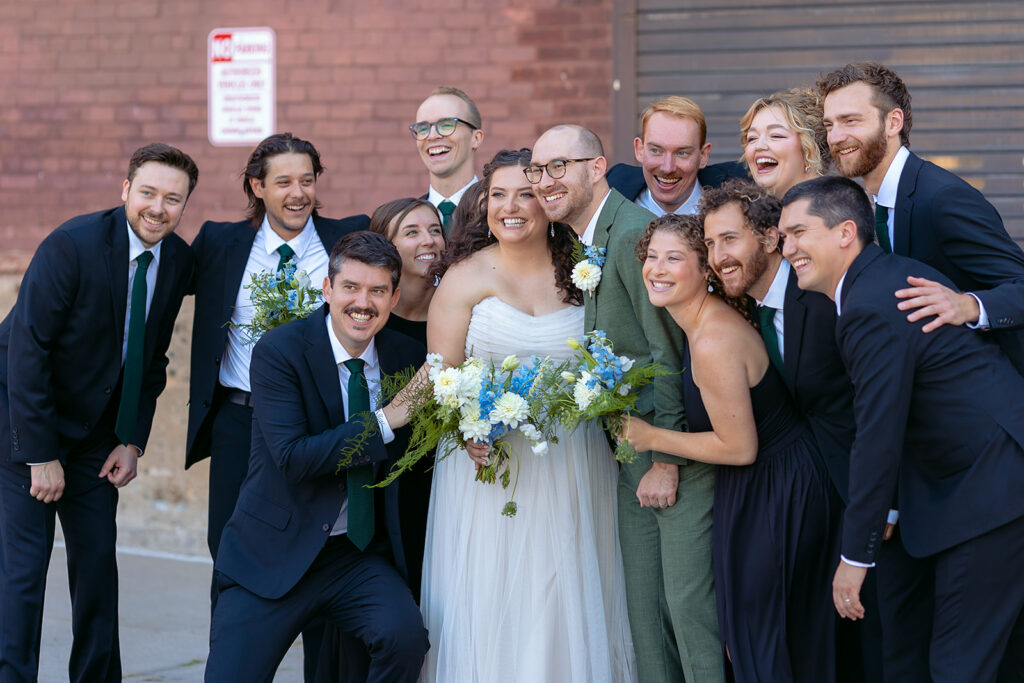 candid bride and groom and their wedding party