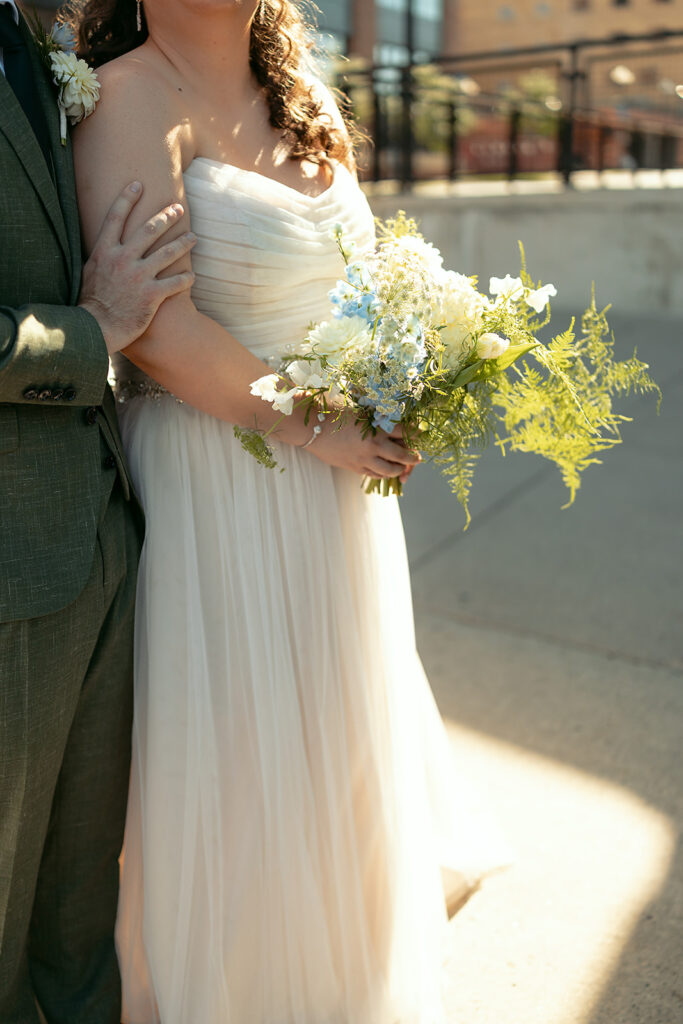 close up of bride and groom hugging