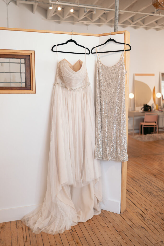 wedding dress hanging from a wall