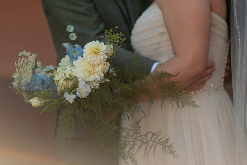 close up of bride and groom hugging