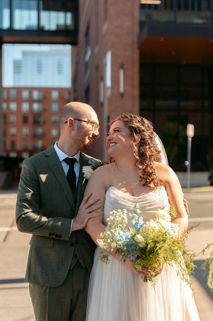bride and groom wandering in downtown minneapolis 
