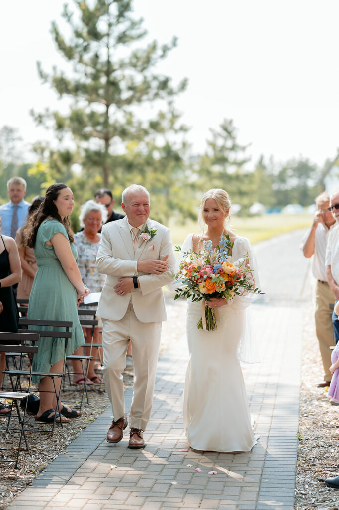 bride and dad walking down the aisle