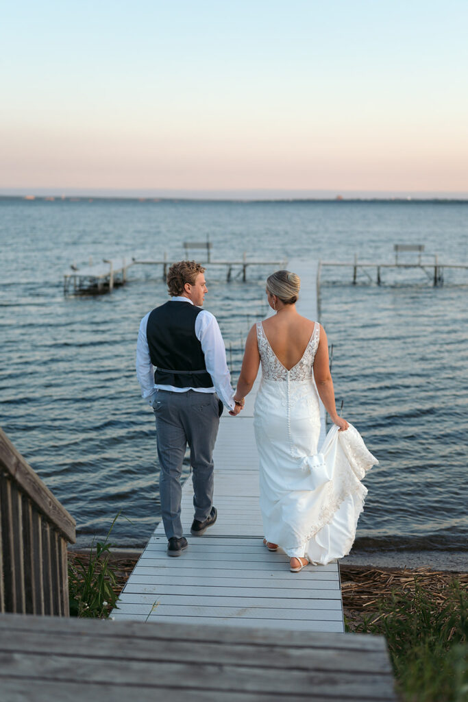 bride and groom on the docks overlooking the lake at the bemidji country club