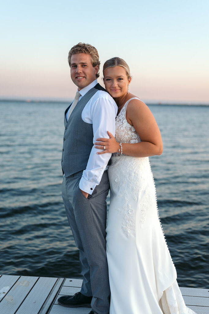 bride and groom on the docks overlooking the lake at the bemidji country club