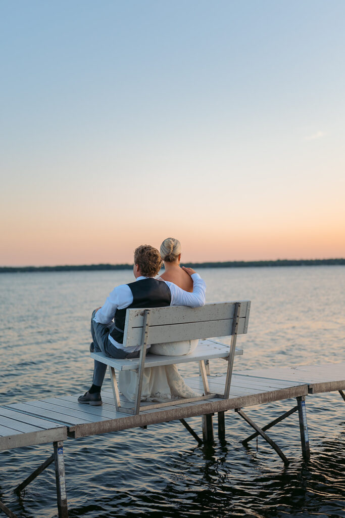 bride and groom on the docks overlooking the lake at the bemidji country club
