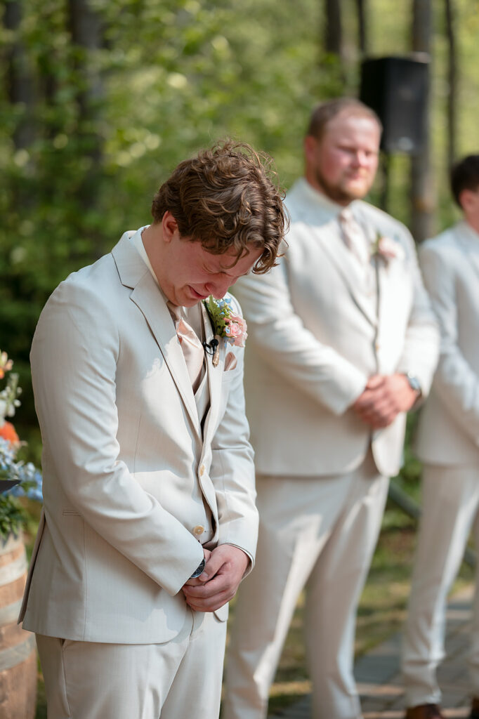 emotional groom seeing his bride walking down the aisle
