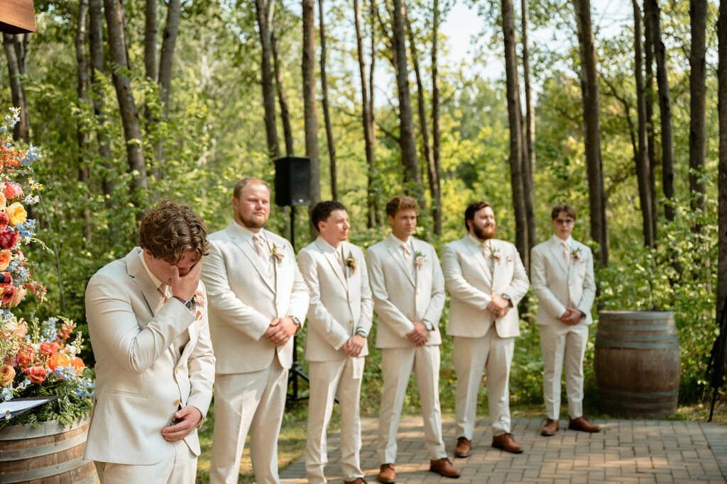 emotional groom seeing his bride walking down the aisle