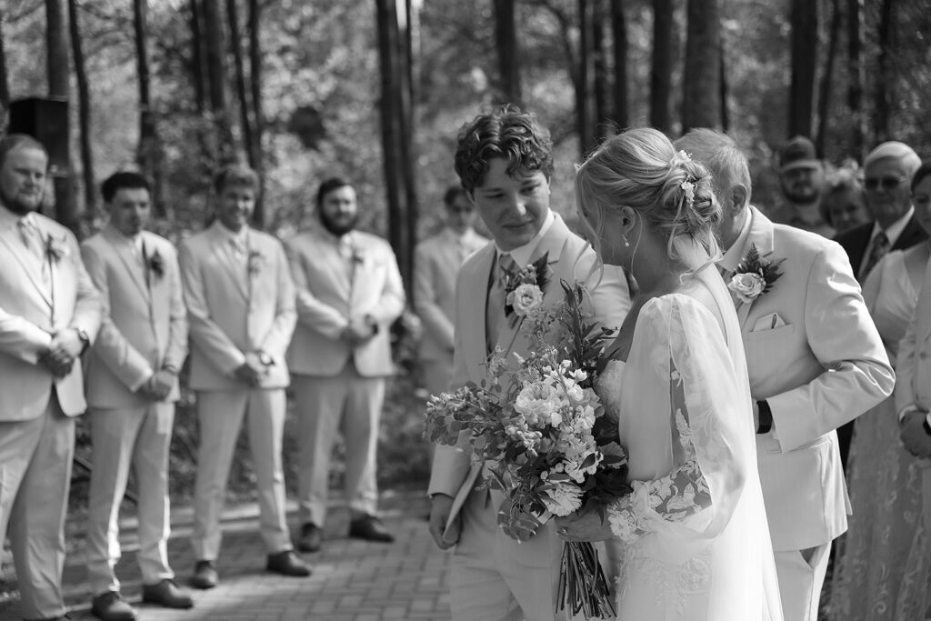 emotional groom seeing his bride walking down the aisle