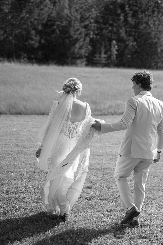 dreamy bride and groom moments in a lush green field during a spring wedding at bluebelle event venue