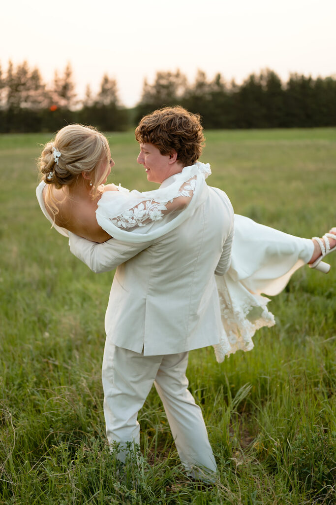 dreamy bride and groom moments in a lush green field during a spring wedding at bluebelle event venue
