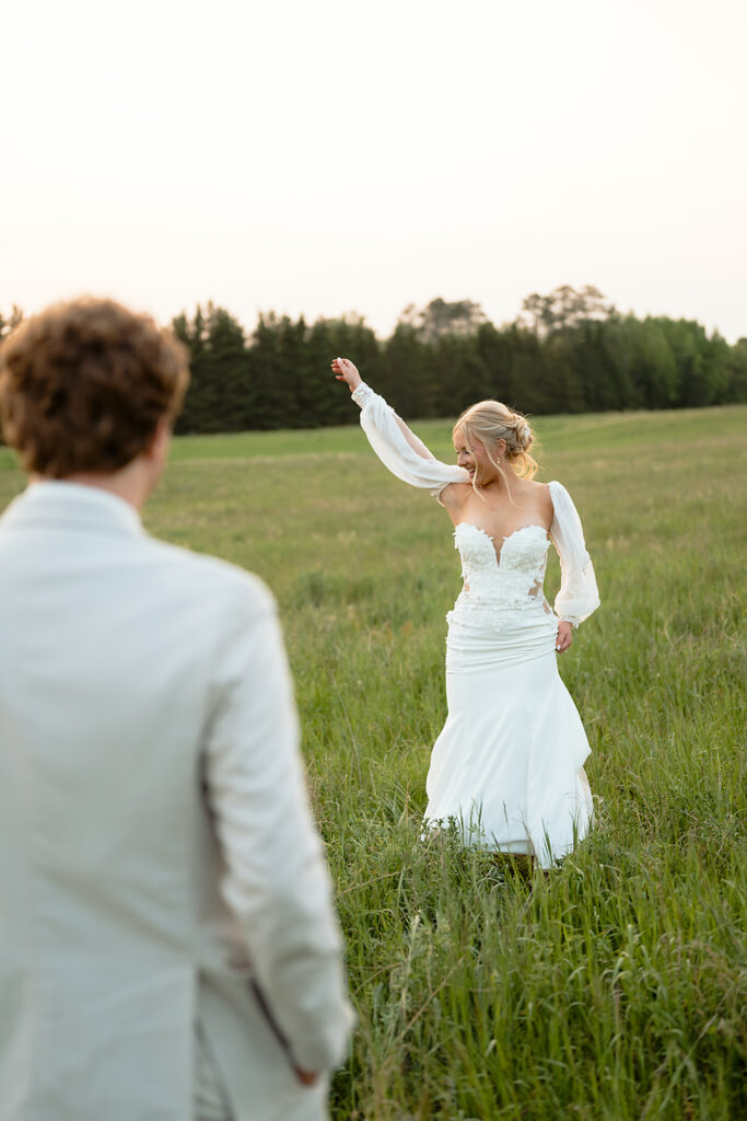 dreamy bride and groom moments in a lush green field during a spring wedding at bluebelle event venue