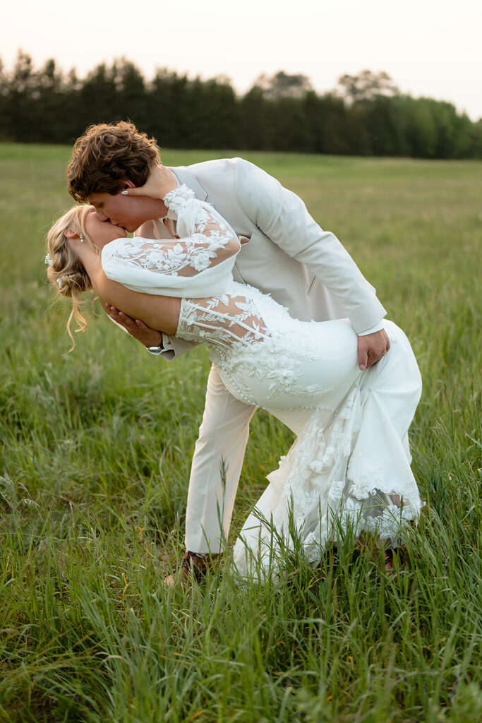 dreamy bride and groom moments in a lush green field during a spring wedding at bluebelle event venue