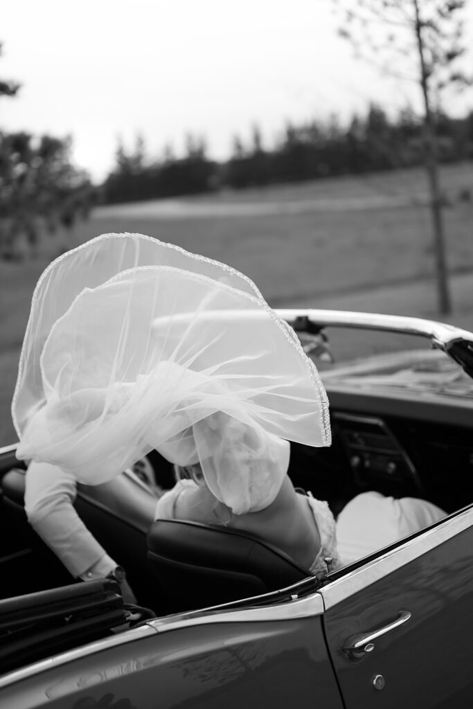 bride and groom in a vintage car during golden hour portraits