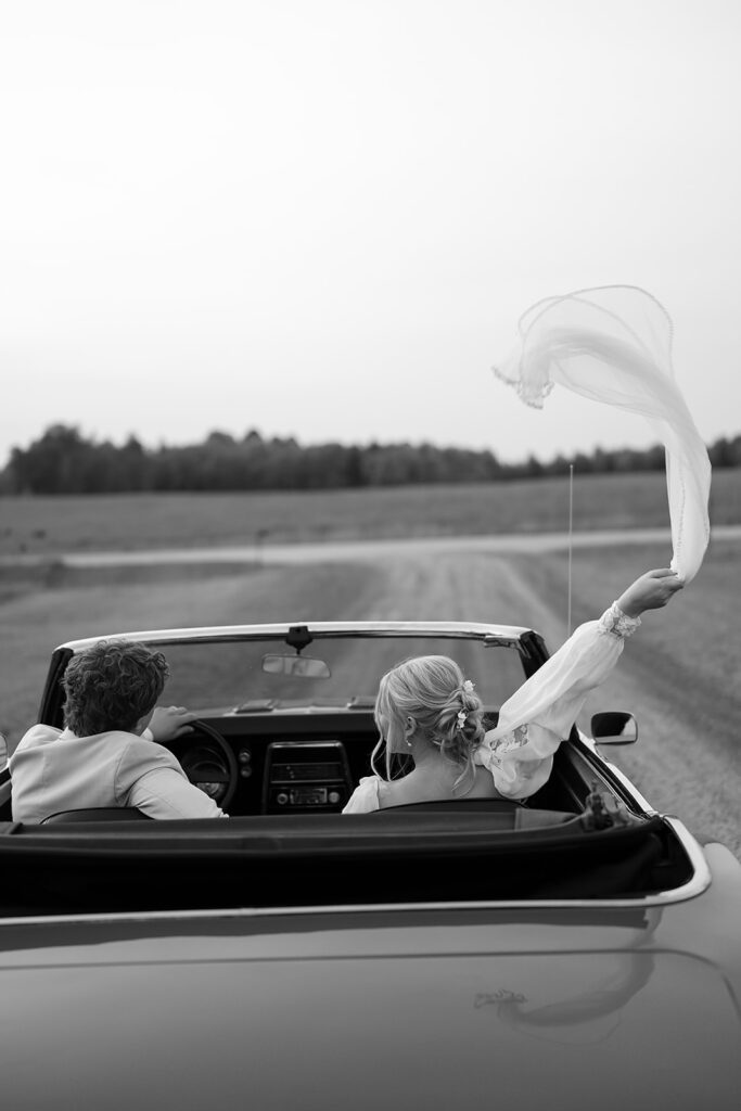 bride and groom in a vintage car during golden hour portraits