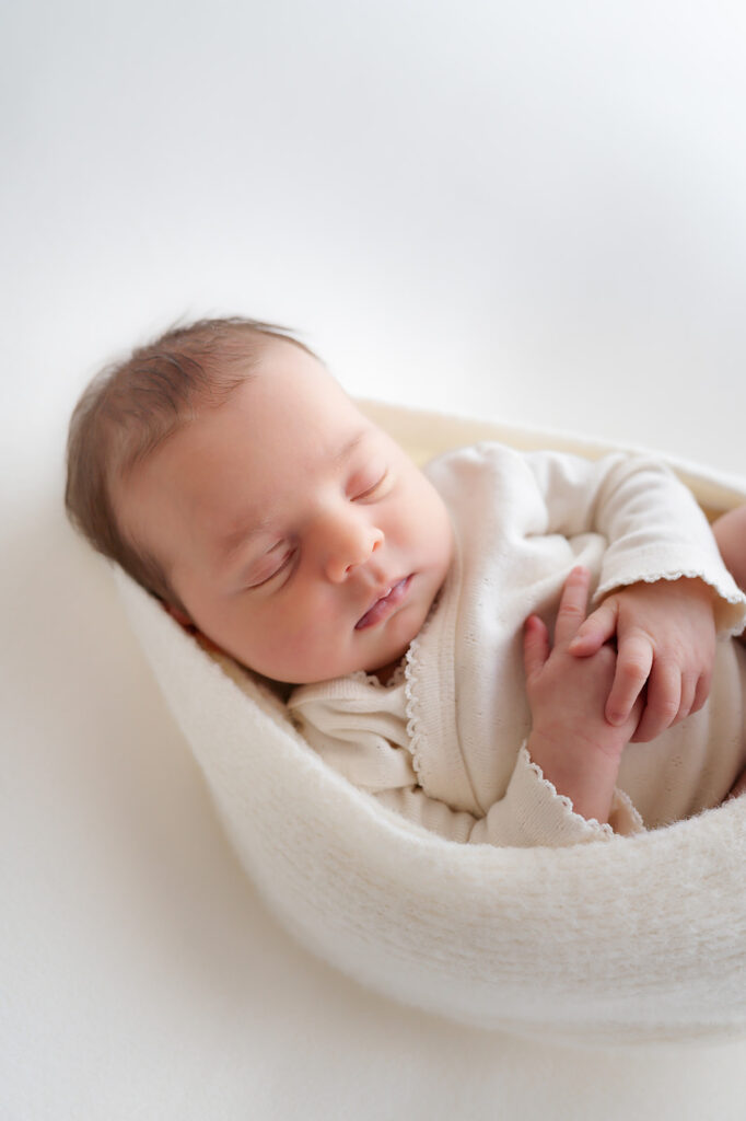 cute and cozy newborn baby swaddled during the newborn studio photography session at the sunroom studio in bemidji mn