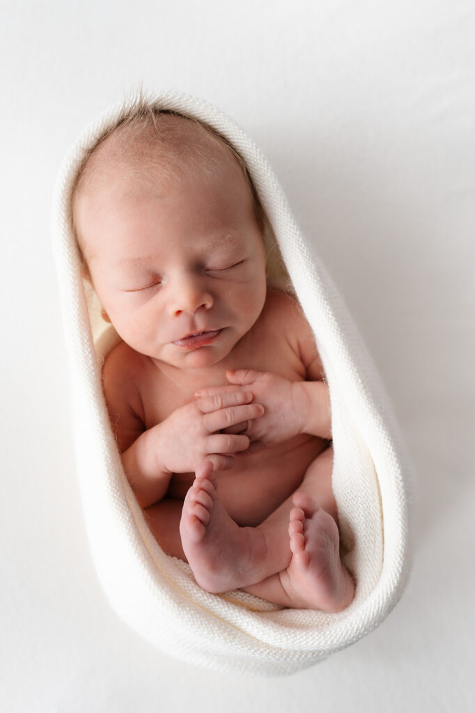 cute and cozy newborn baby swaddled during the newborn studio photography session at the sunroom studio in bemidji mn