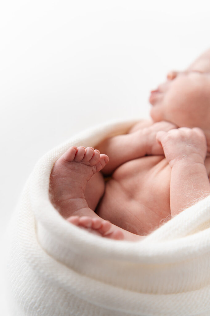 cute and cozy newborn baby swaddled during the newborn studio photography session at the sunroom studio in bemidji mn