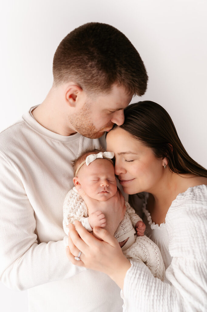 family with their newborn baby in a light timeless studio in bemidji mn