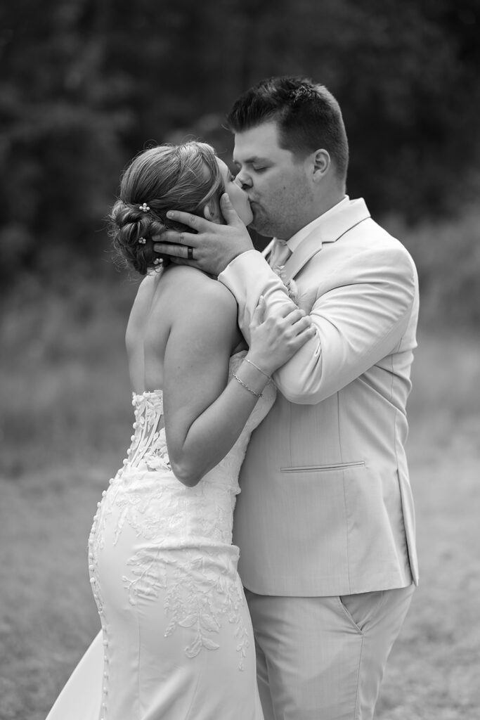 playful bride and groom in a lush field during golden hour at the bluebelle event venue