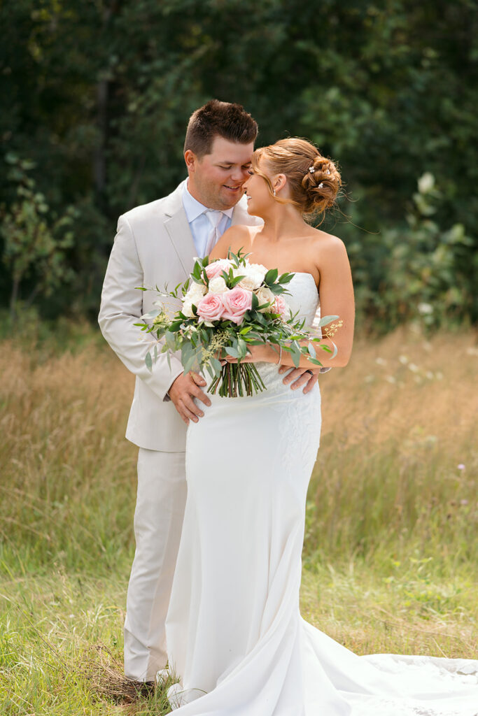 bride and groom in a lush field during golden hour at the bluebelle event venue