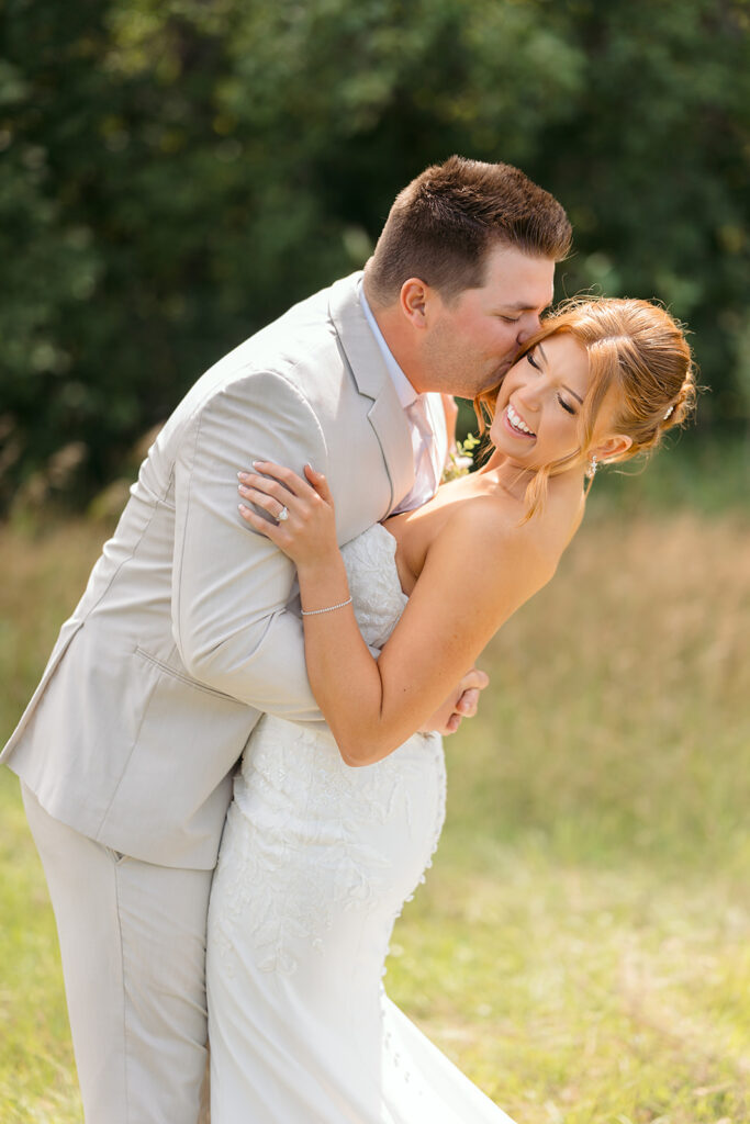 bride and groom in a lush field during golden hour at the bluebelle event venue