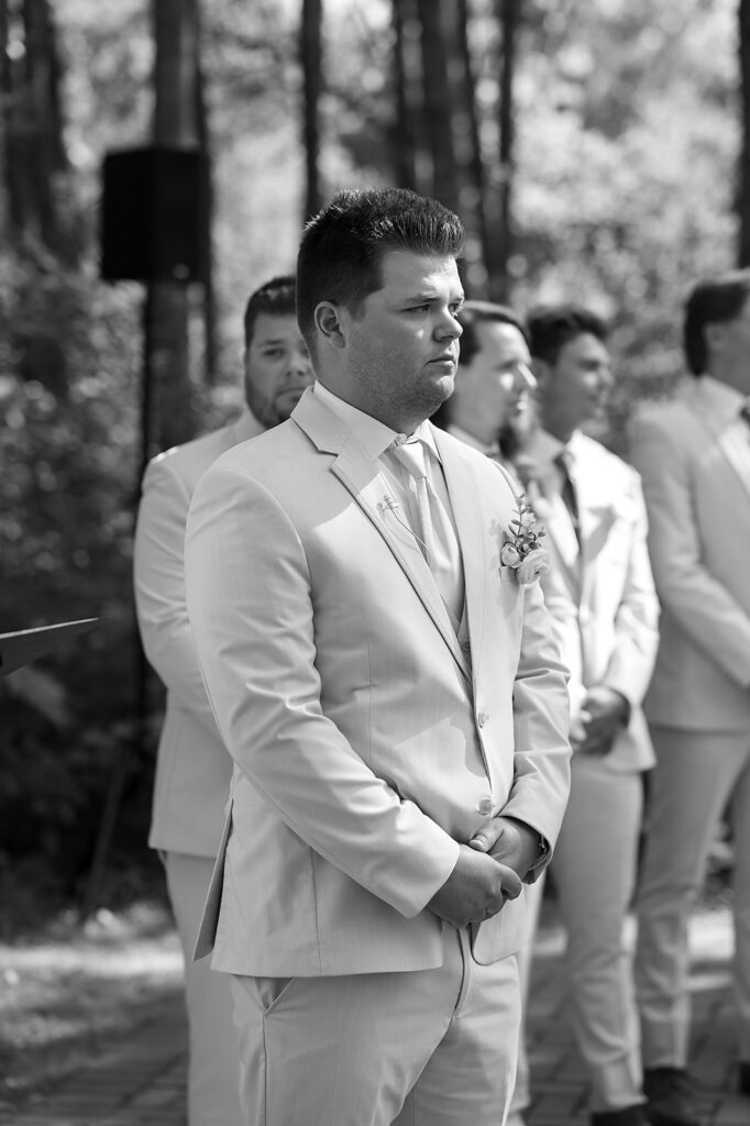 groom waiting at the end of the aisle
