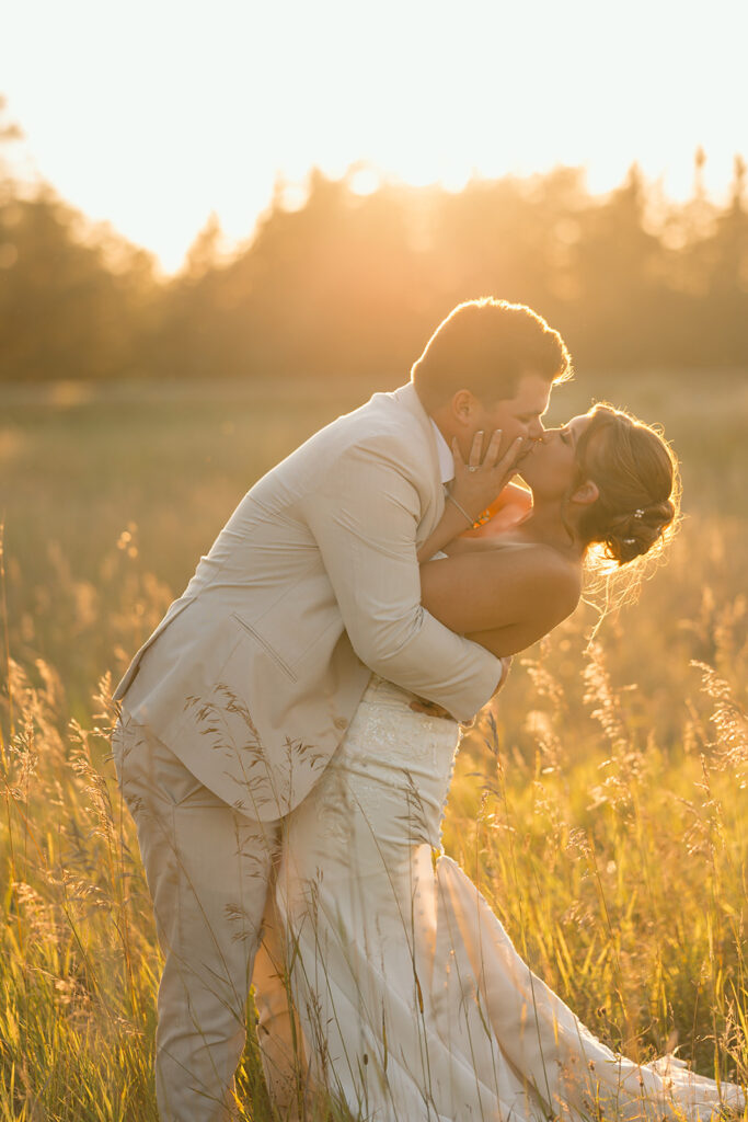 bride and groom in a lush field during golden hour at the bluebelle event venue