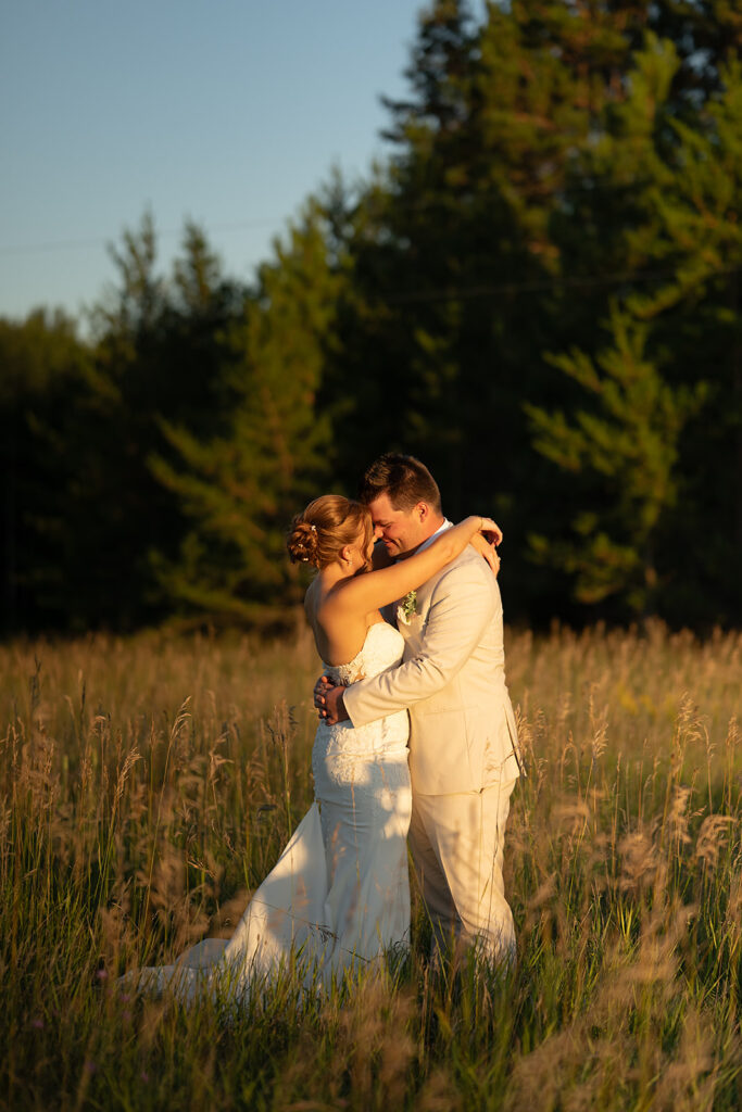 bride and groom in a lush field during golden hour at the bluebelle event venue