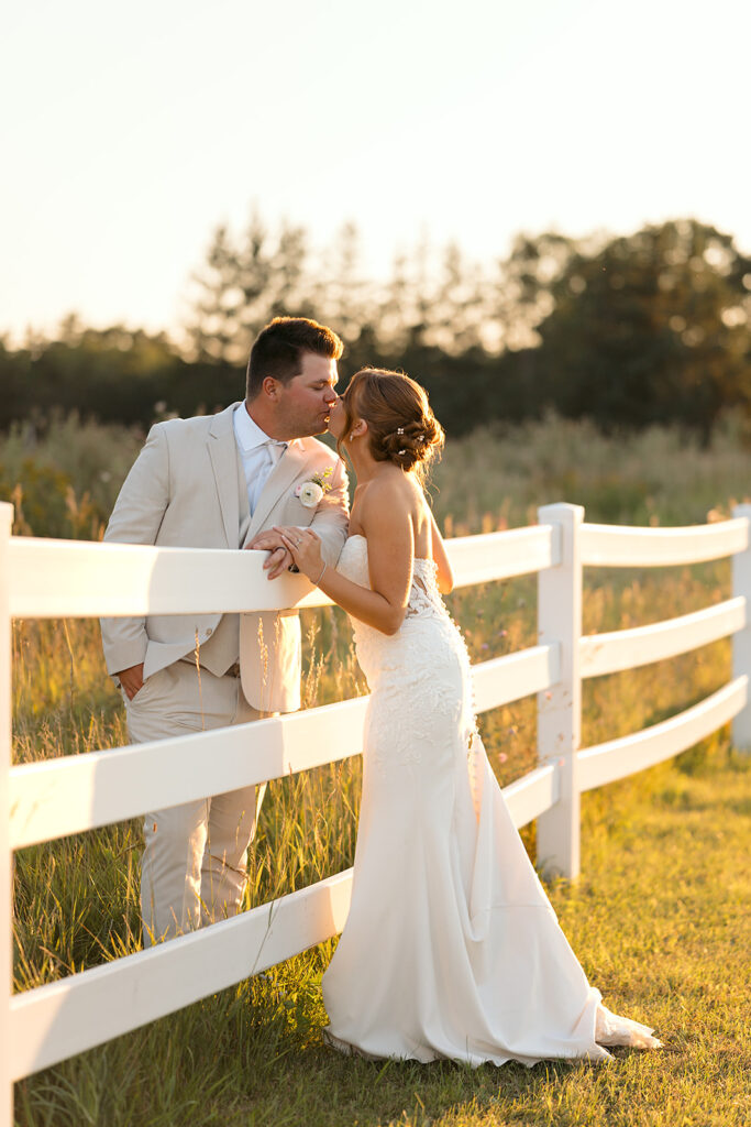 bride and groom in a lush field during golden hour at the bluebelle event venue