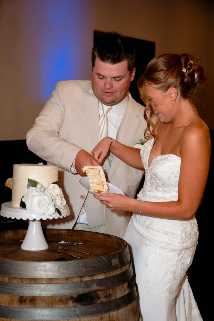 bride and groom cutting cake at the bluebelle event venue
