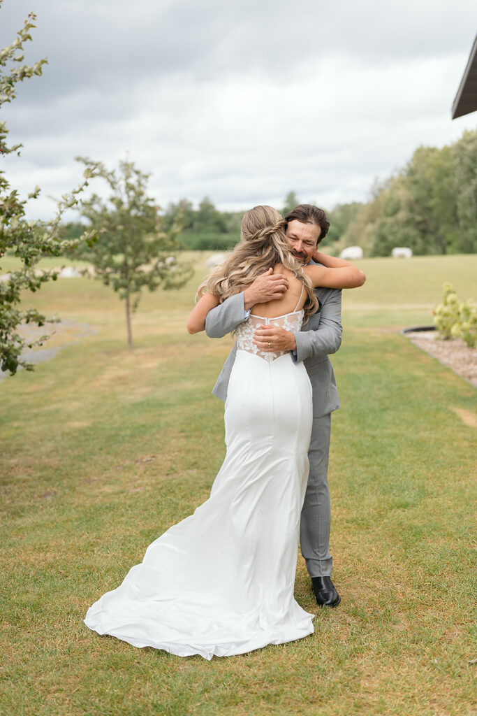 emotional bride and dad first look
