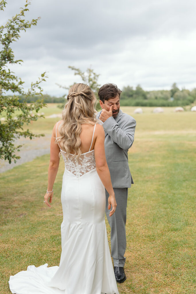 emotional bride and dad first look