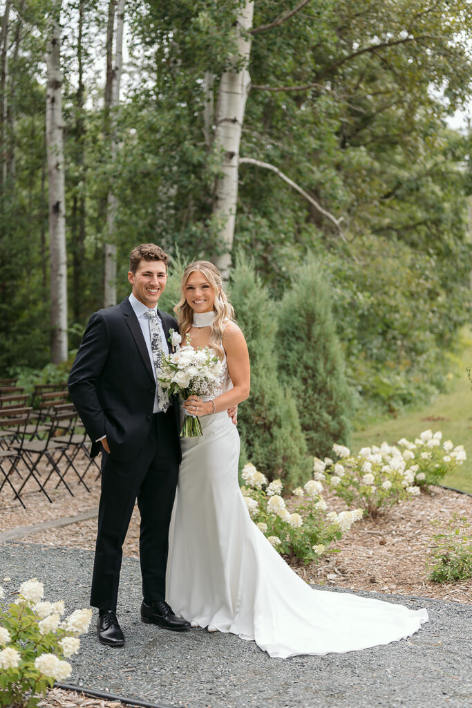 romantic bride and groom moment at the outdoor ceremony location in bluebelle event venue, bemidji, mn