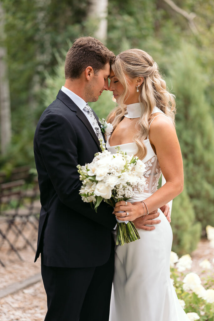 romantic bride and groom moment at the outdoor ceremony location in bluebelle event venue, bemidji, mn