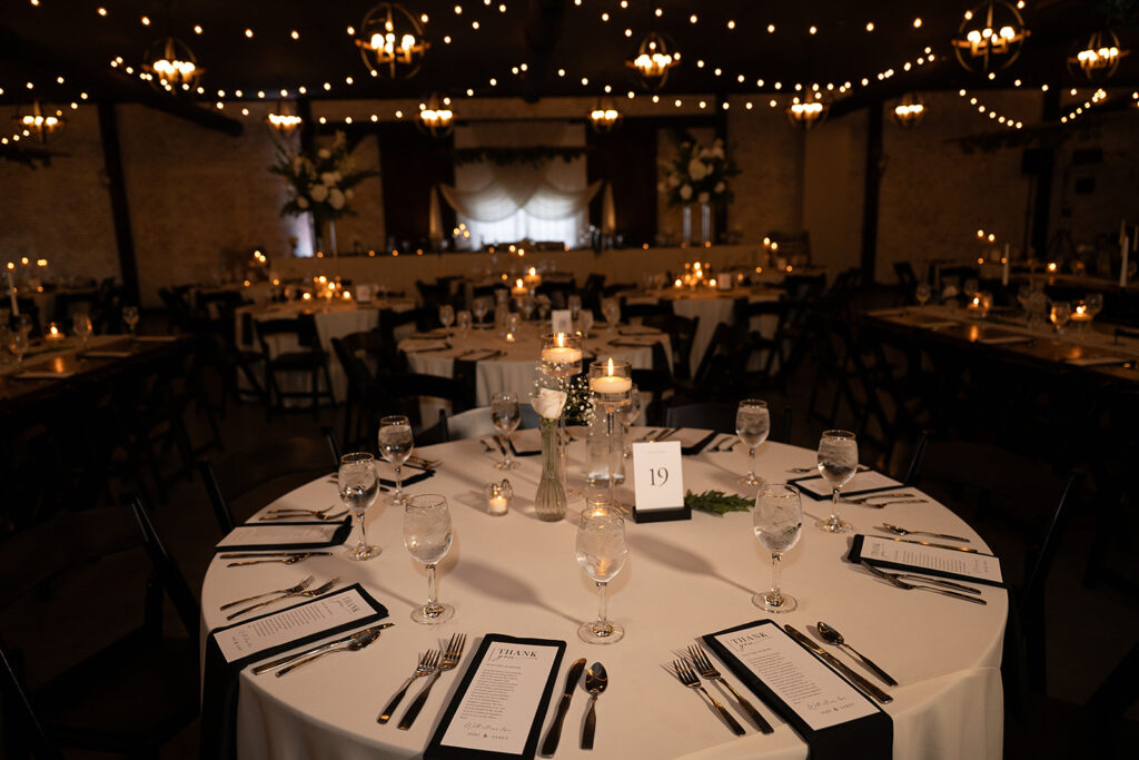 elegant black and white wedding table settings for an indoor reception at the bluebelle event venue