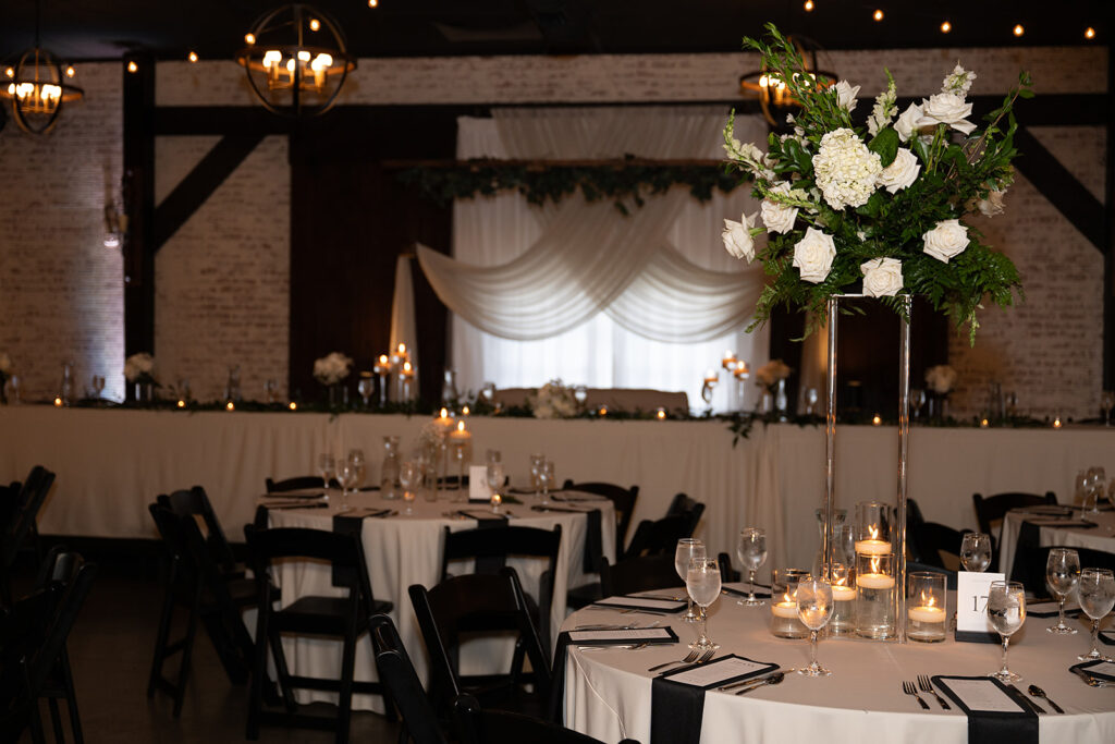elegant black and white wedding table settings for an indoor reception at the bluebelle event venue