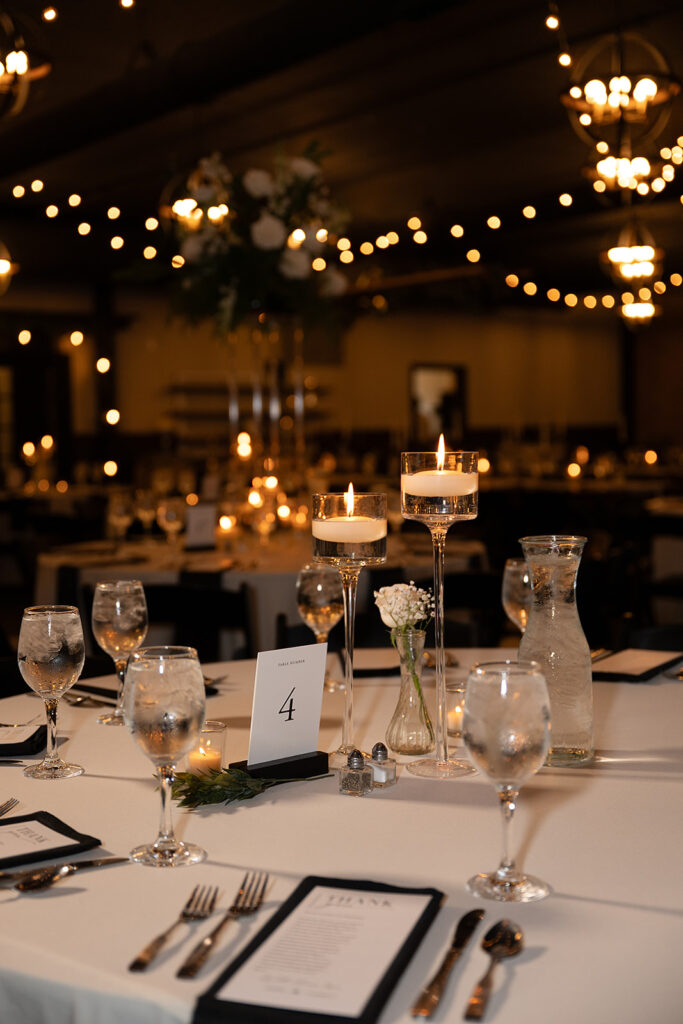 elegant black and white wedding table settings for an indoor reception at the bluebelle event venue