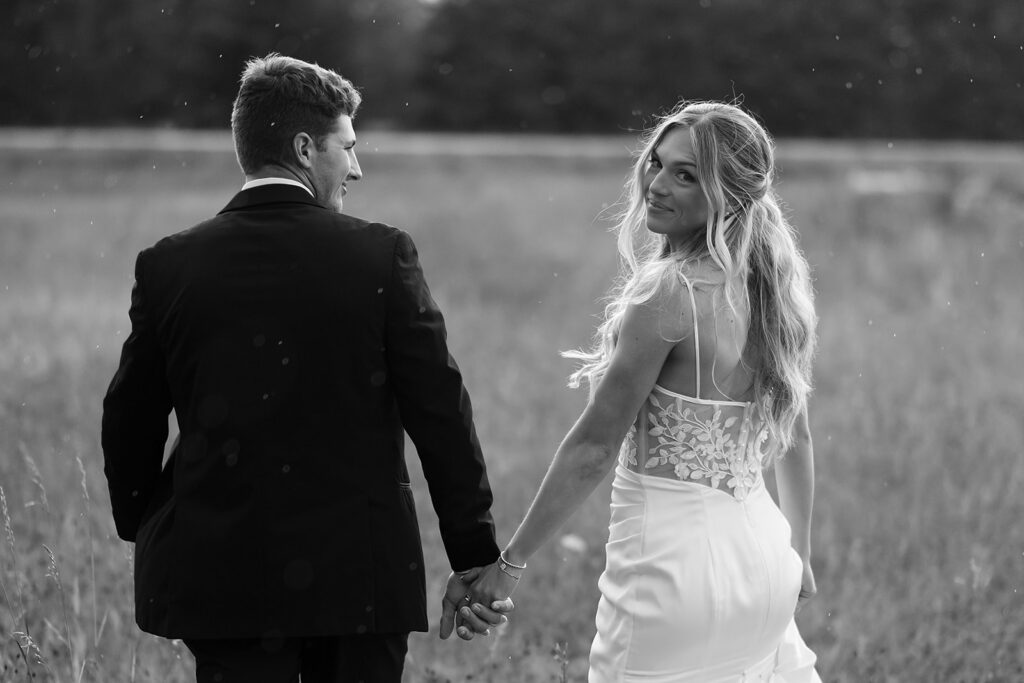 romantic rainy wedding photos at a lush field