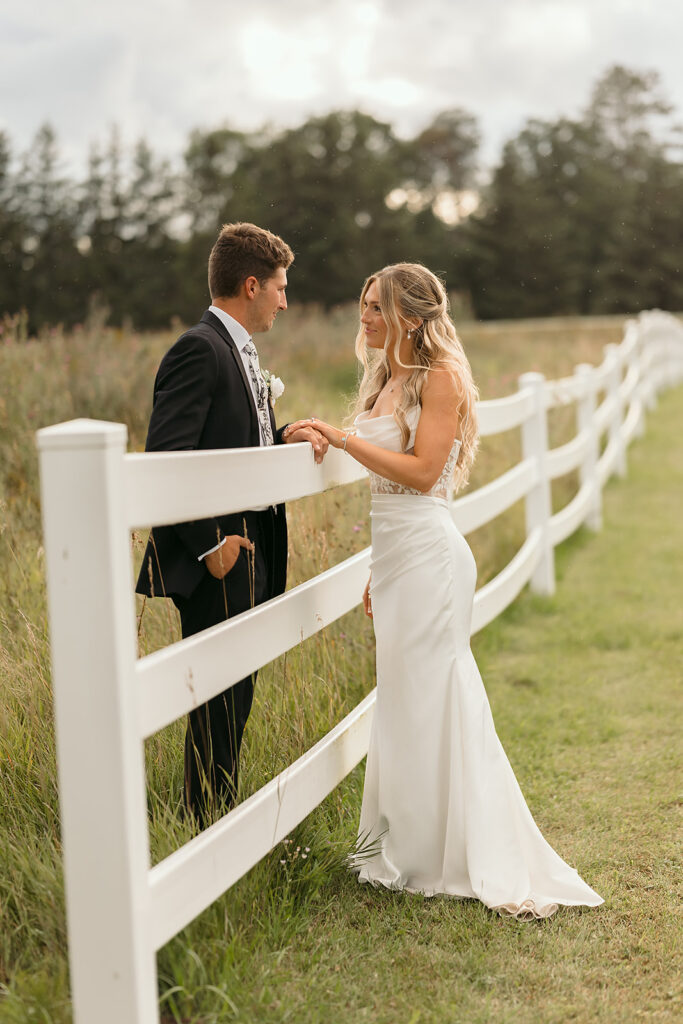 romantic rainy wedding photos at a lush field