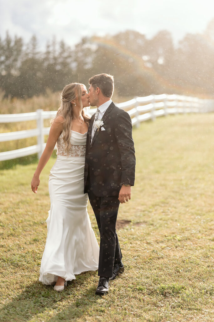 romantic rainy wedding photos at a lush field