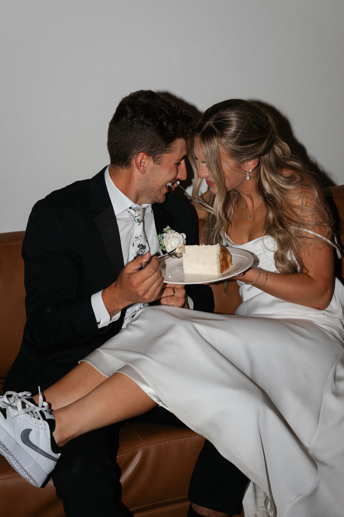 bride and groom sharing a slice of cake
