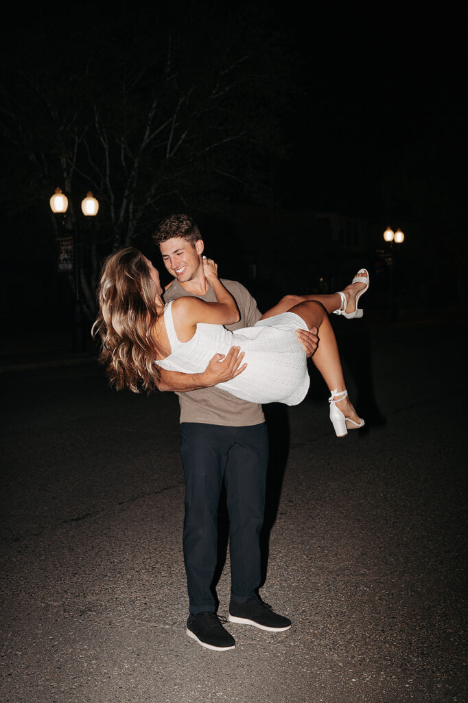 playful couple and direct flash downtown bemidji engagement photos