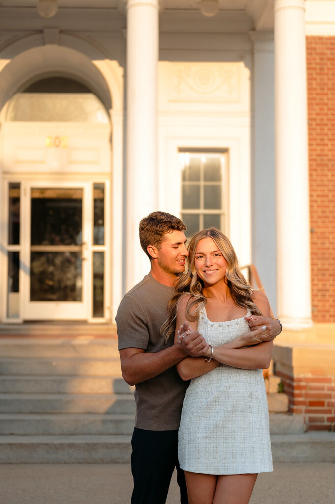 sweet couple hugging during golden hour for their downtown engagement photos in Bemidji