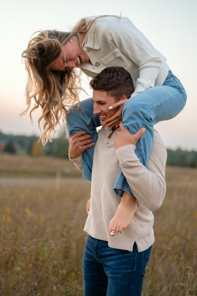 couple being playful during blue hour in a lush golden field
