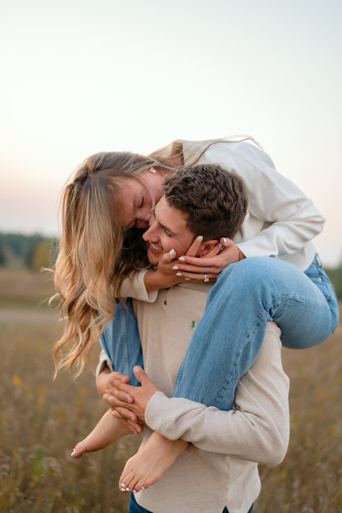 couple being playful during blue hour in a lush golden field