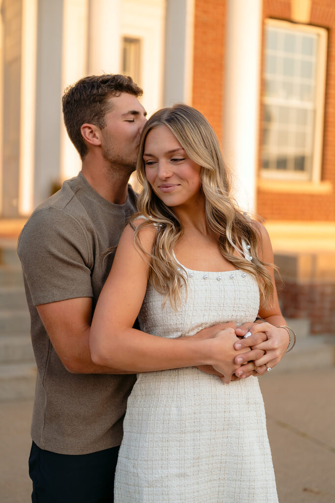sweet couple hugging during golden hour for their downtown engagement photos in Bemidji