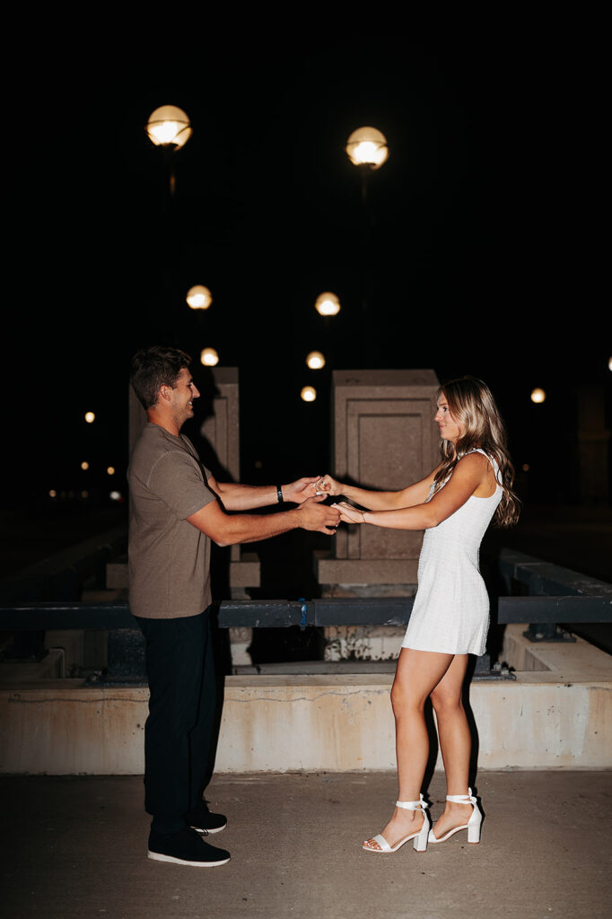 playful couple and direct flash downtown bemidji engagement photos