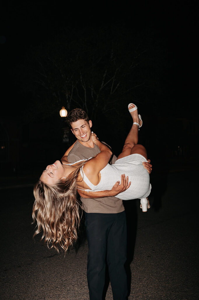 playful couple and direct flash downtown bemidji engagement photos