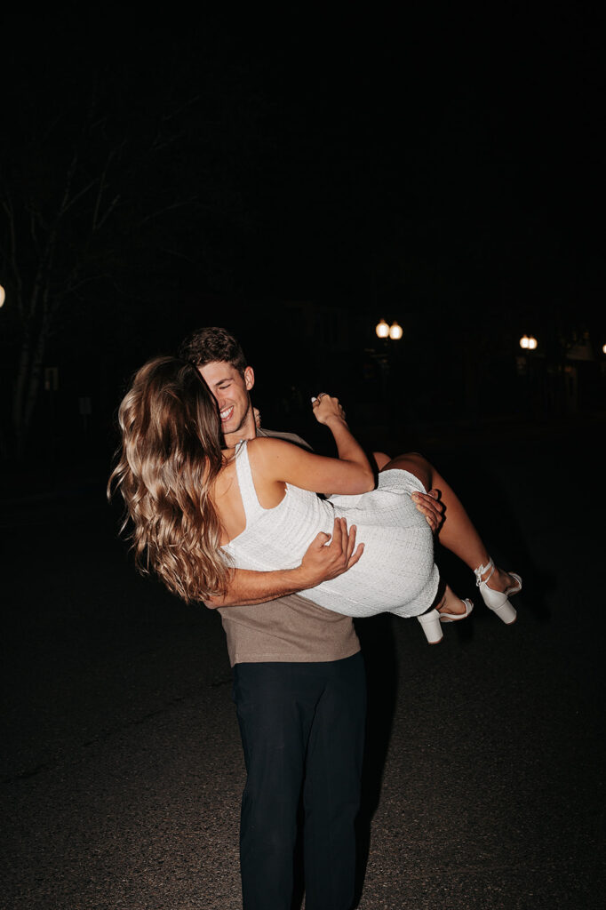 playful couple and direct flash downtown bemidji engagement photos